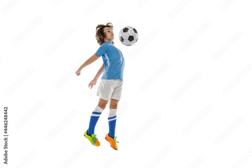 Portrait of little male football soccer player, boy training with football ball isolated on white studio background. Concept of sport, game, hobby Portrait of little male football soccer player, boy training with football ball isolated on white studio background. Concept of sport, game, hobby