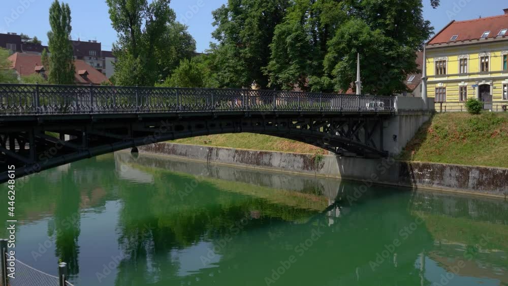 View of famous Hradecky Bridge in Ljubljana downtown, Slovenia. This is one of the first hinged bridges in the world. Handheld, real time View of famous Hradecky Bridge in Ljubljana downtown, Slovenia. This is one of the first hinged bridges in the world. Handheld, real time