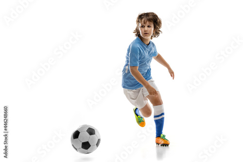 Young sportsman, football soccer player, child playing football isolated on white studio background. Concept of sport, game, hobby