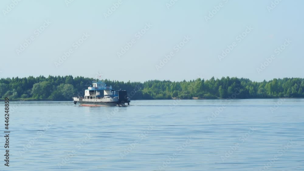 Small Ferryboat on a Volga River with the blue sky background. Transport ferry - transportation of people and cars. Small Ferryboat on a Volga River with the blue sky background. Transport ferry - transportation of people and cars.