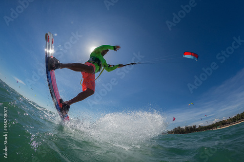 A kite surfer rides the waves