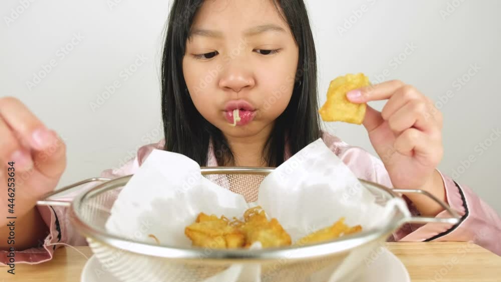 Asian child girls enjoying delicious fried golden needle mushroom dumplings with ASMR sound Asian child girls enjoying delicious fried golden needle mushroom dumplings with ASMR sound