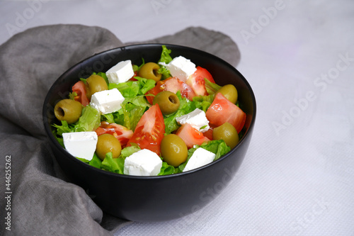 A fresh vegetable salad. Salad with olives, feta cheese, cucumbers, tomatoes.