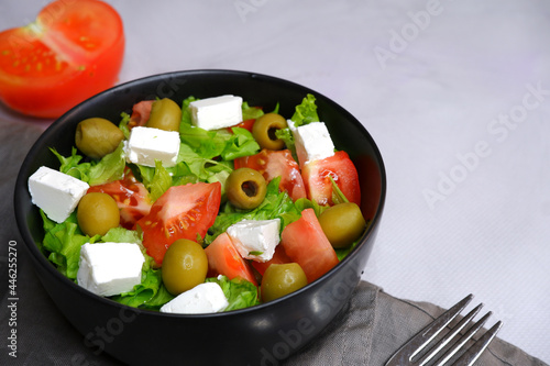 A fresh vegetable salad. Salad with olives, feta cheese, cucumbers, tomatoes.