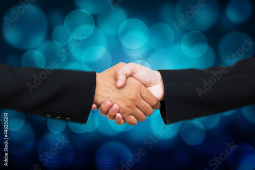 Hand shake on bokeh background,businesspeople are shaking their hands after signing a contract