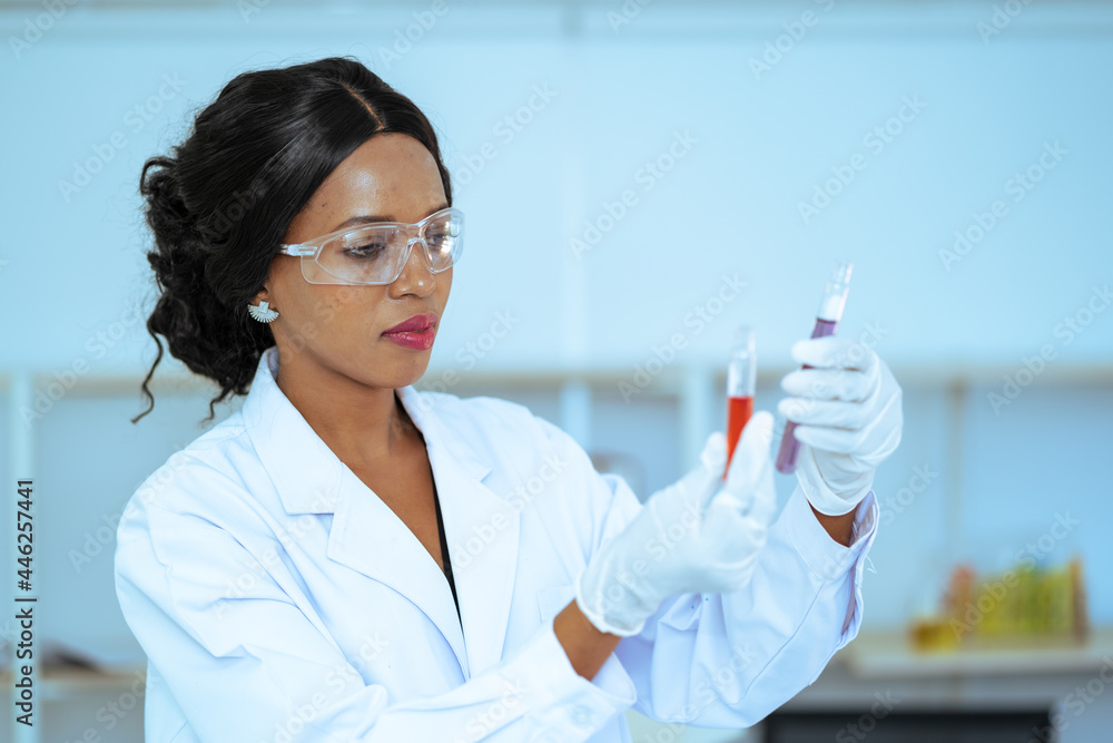 Scientist in laboratory with holding a test tube. Medical healthcare technology and pharmaceutical research and development concept Scientist in laboratory with holding a test tube. Medical healthcare technology and pharmaceutical research and development concept