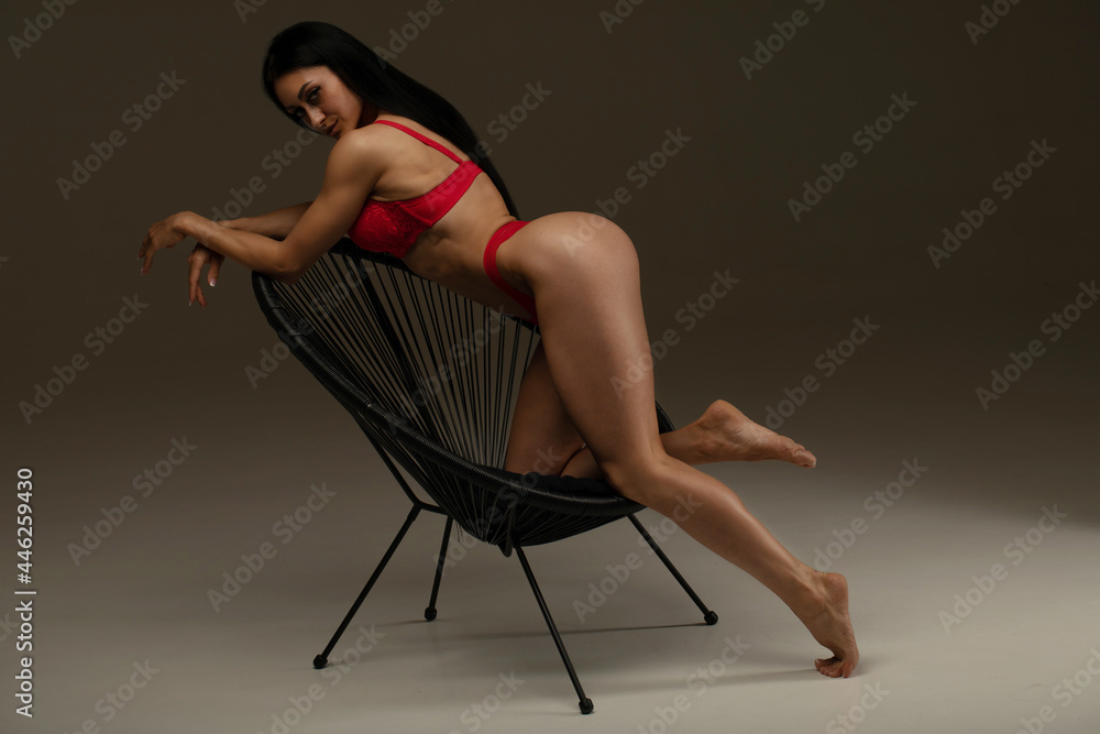 Pretty elegant woman in beautiful red lingerie against dark grey background Pretty elegant woman in beautiful red lingerie against dark grey background