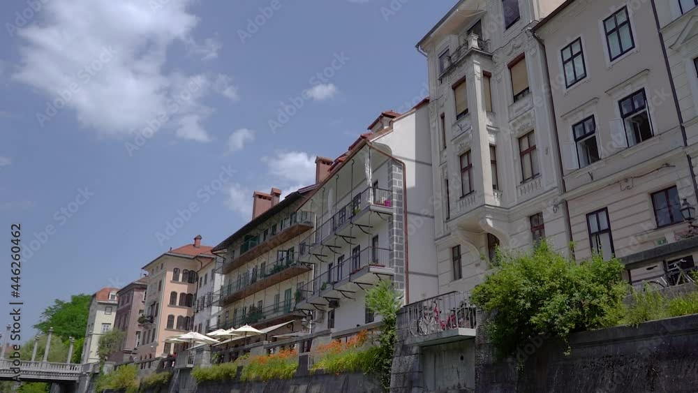 Cityscape view from boat, Ljubljana, Slovenia. Navigating on Ljubljanica river towards Cobblers bridge. Unique perspective of medieval downtown in hot summer day. Slow motion, forward dolly moving Cityscape view from boat, Ljubljana, Slovenia. Navigating on Ljubljanica river towards Cobblers bridge. Unique perspective of medieval downtown in hot summer day. Slow motion, forward dolly moving