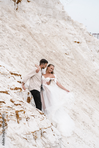 Beautiful wedding couple bride and groom at wedding day outdoors at ocean beach. Happy marriage couple o