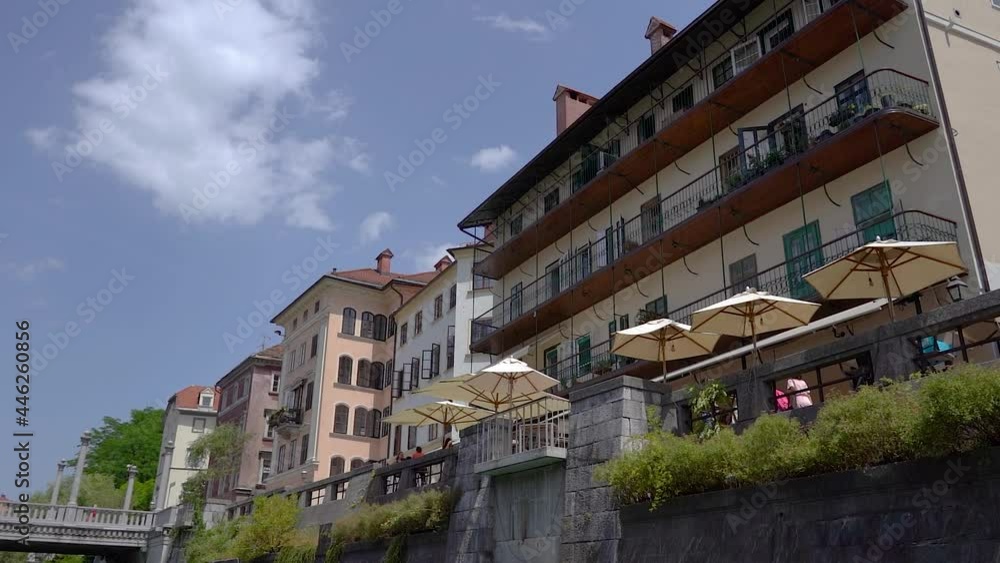 Cityscape view from boat, Ljubljana, Slovenia. Navigating on Ljubljanica river under Cobblers bridge. Unique perspective of medieval downtown in hot summer day. Slow motion, forward dolly moving Cityscape view from boat, Ljubljana, Slovenia. Navigating on Ljubljanica river under Cobblers bridge. Unique perspective of medieval downtown in hot summer day. Slow motion, forward dolly moving