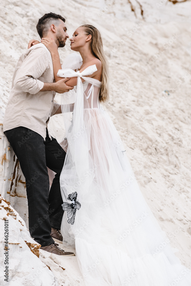 Beautiful wedding couple bride and groom at wedding day outdoors at ocean beach. Happy marriage couple o