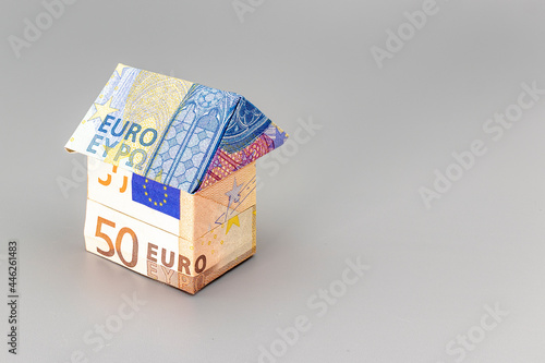 Purchase and sale of housing. Mortgage for the purchase of a house. Rental Property. House folded from euro banknotes. Origami. Close-up. Copy space. Housing in Europe.
