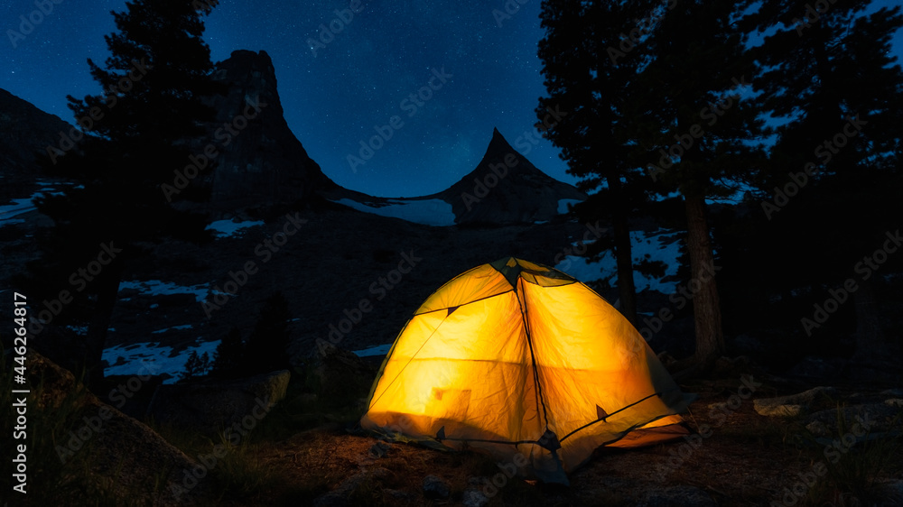 Yellow tent in the night starry sky. Mountain Parabola