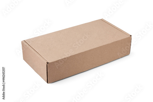 Rectangular flat cardboard box for packing parcels or gifts lies horizontally at an angle, isolated on white.