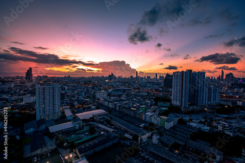 The high angle background of the city view with the secret light of the evening, blurring of night lights, showing the distribution of condominiums, dense homes in the capital community