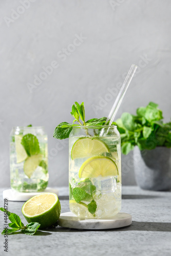 Freshness mojito cocktails of white rum, soda, lime and mint on gray background. Vertical. Close up.