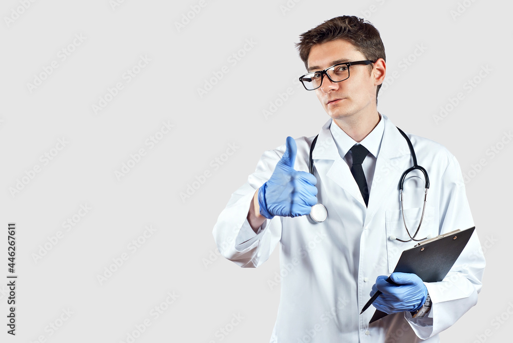 Doctor with a stethoscope on a white background. A man in a medical gown with glasses. Doctor with a tablet and a pen in his hands. Doctor with a stethoscope on a white background. A man in a medical gown with glasses. Doctor with a tablet and a pen in his hands.