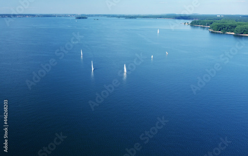 Aerial view of white yachts with sail. Ships in the blue sea