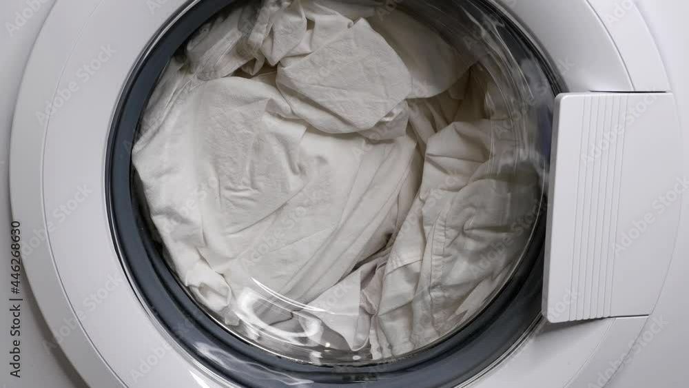 Washing in a washing machine. Water is poured into the washing machine to get started. Washing in a washing machine. Water is poured into the washing machine to get started.