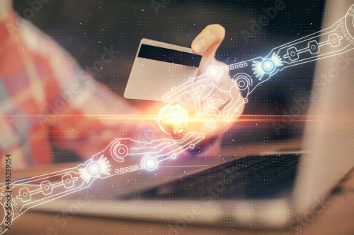 Double exposure of man hands holding a credit card and data theme drawing. E-commerce and technology concept.