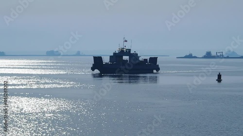 Silhouette of ferryboat on a Volga river in the haze of early morning. 
Transport ferry - transportation of people and cars from Verhniy Uslon to Kazan city, Tatarstan, Russia. photo