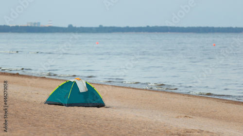 Tent on a sandy beach near water