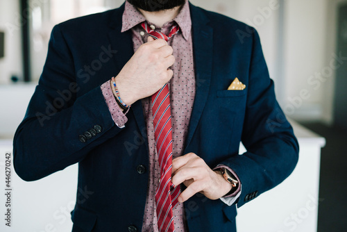 Business Man straightening  red tie