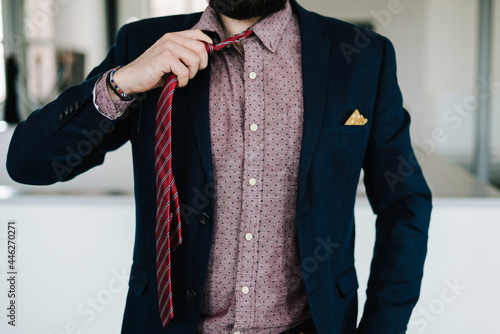 Business Man untying red tie