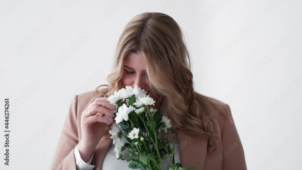 8 march gift. Online dating. Romantic present. Spring holiday congratulation. Body positive. Portrait of happy obese overweight woman with white flowers bouquet isolated on light. 8 march gift. Online dating. Romantic present. Spring holiday congratulation. Body positive. Portrait of happy obese overweight woman with white flowers bouquet isolated on light.