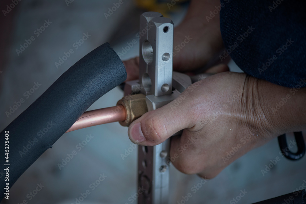 Image of Air conditioner technician is connecting pipes to bring home air conditioners.,air conditioning equipment.