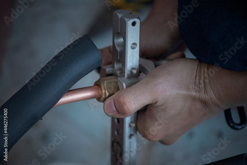 Image of Air conditioner technician is connecting pipes to bring home air conditioners.,air conditioning equipment.