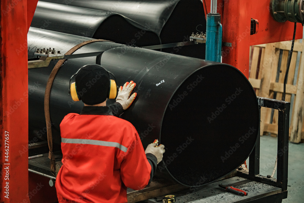 custom made wallpaper toronto digitala worker of a pipe-rolling plant. conveyor line of the ferrous metallurgy enterprise. a worker in a uniform is engaged in metal welding