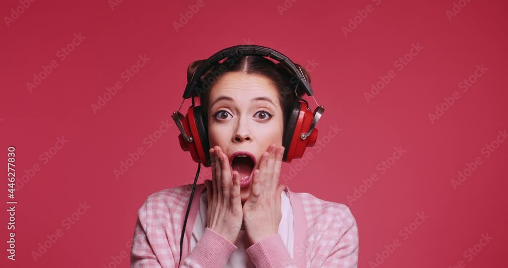 Young caucasian pretty teen girl says wow reacts on great music song ...