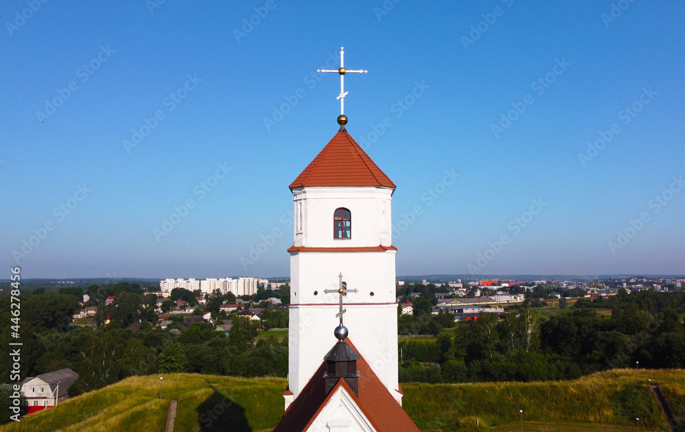 Aerial view of the cross on the tower. Medieval European church with Romanesque architecture