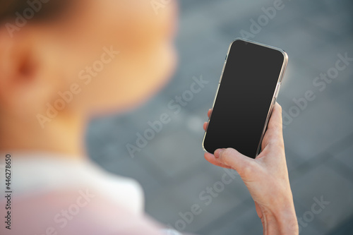 Close up of a businesswoman using smartphone outdoors in the city