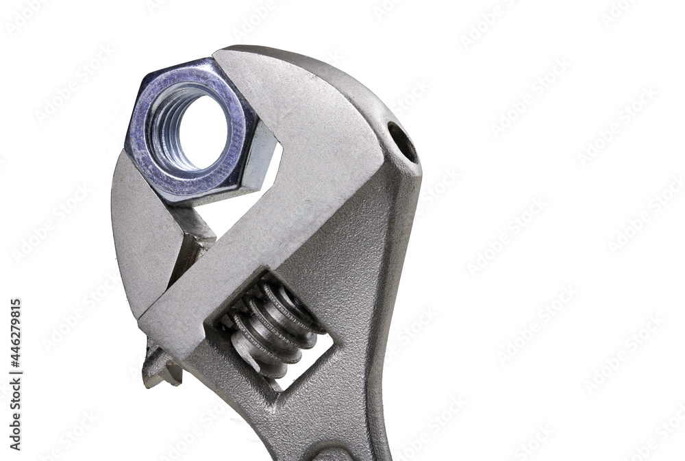 Adjustable wrench and metal nut. Tools for assembling appliances in a home workshop. Adjustable wrench and metal nut. Tools for assembling appliances in a home workshop.