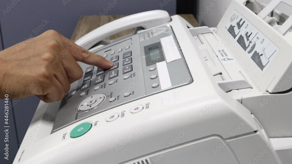 hand man is using a fax machine in the office, equipment for data transmission. hand man is using a fax machine in the office, equipment for data transmission.
