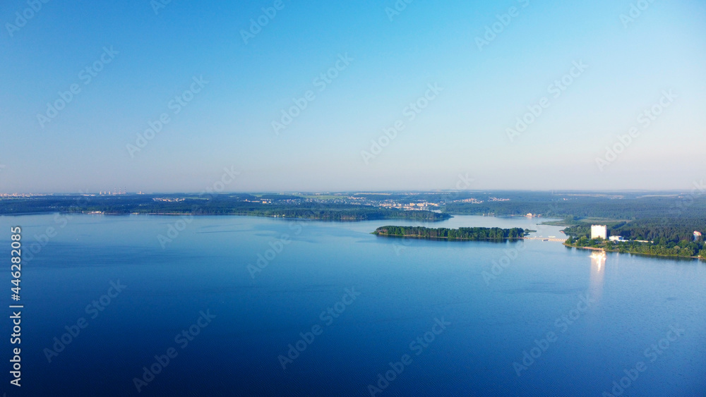 Aerial view of blue lake water landscape at sunrise