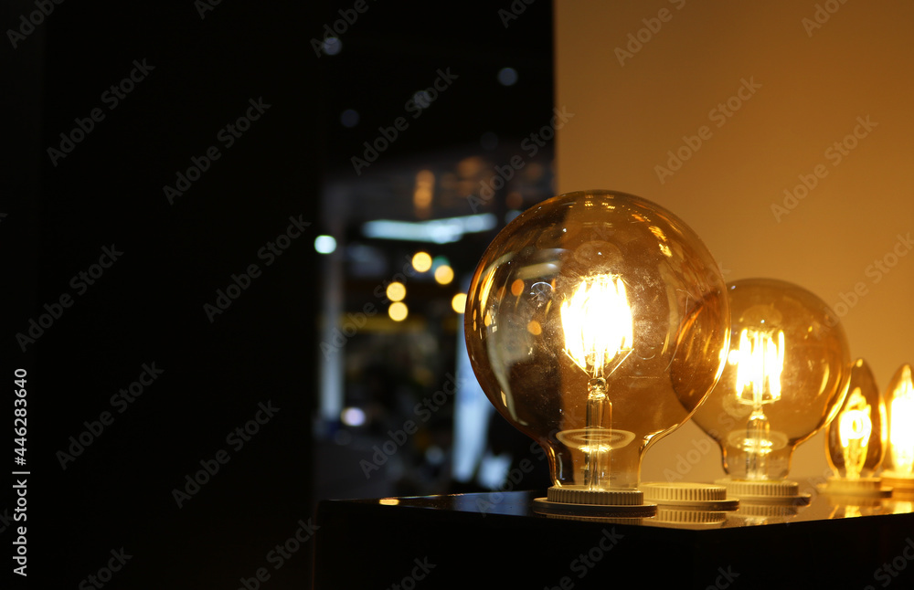 Vintage edison light bulb glowing in dark light.