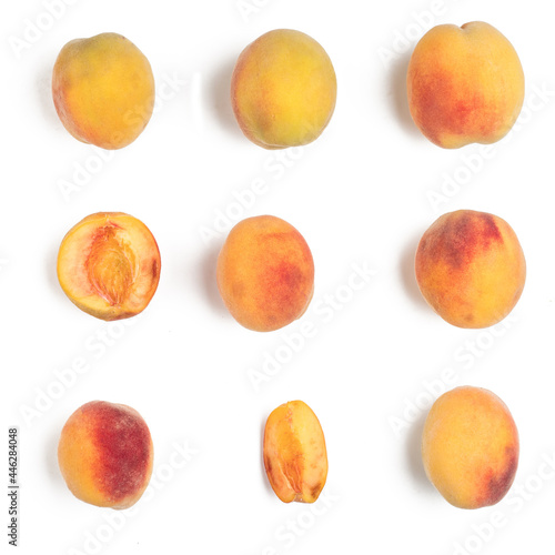 Several ripe peaches on a white background. View from above.