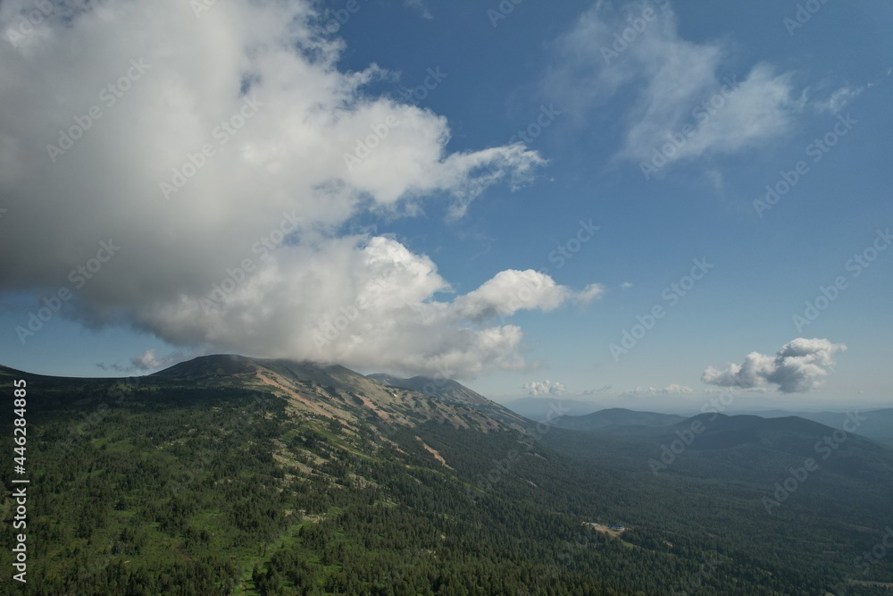 AERIAL: an epic panorama of mountains with thunderclouds. shot of adventure hiking in mountains alone outdoor active lifestyle travel vacations. Conceptual scene AERIAL: an epic panorama of mountains with thunderclouds. shot of adventure hiking in mountains alone outdoor active lifestyle travel vacations. Conceptual scene