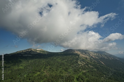 AERIAL: an epic panorama of mountains with thunderclouds. shot of adventure hiking in mountains alone outdoor active lifestyle travel vacations. Conceptual scene