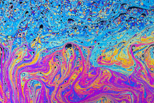 Fluid soap bubble psychedelic colorful abstract art. Surreal patterns with rainbows and waves of color in motion.