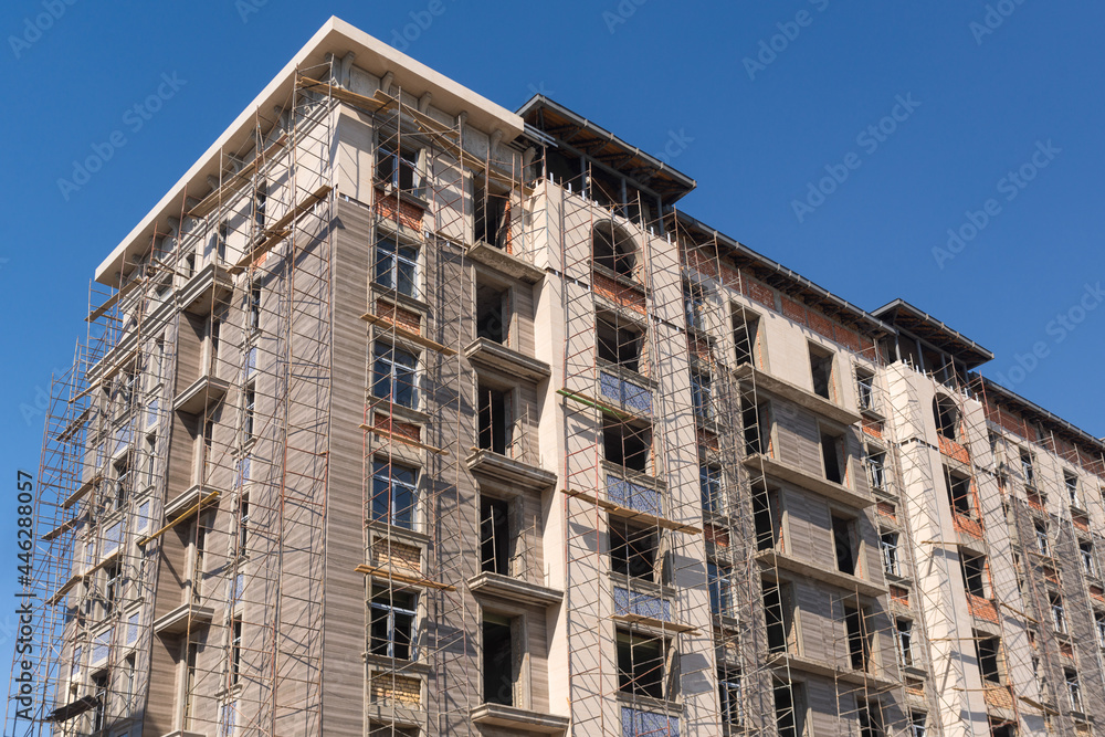 Finishing works on the facade of a new residential buildings