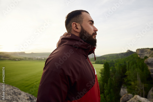 Young bearded man portrait outdoors in the mountains