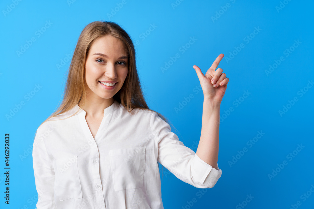 Pretty nice young woman pointing to copy space for advertising Pretty nice young woman pointing to copy space for advertising
