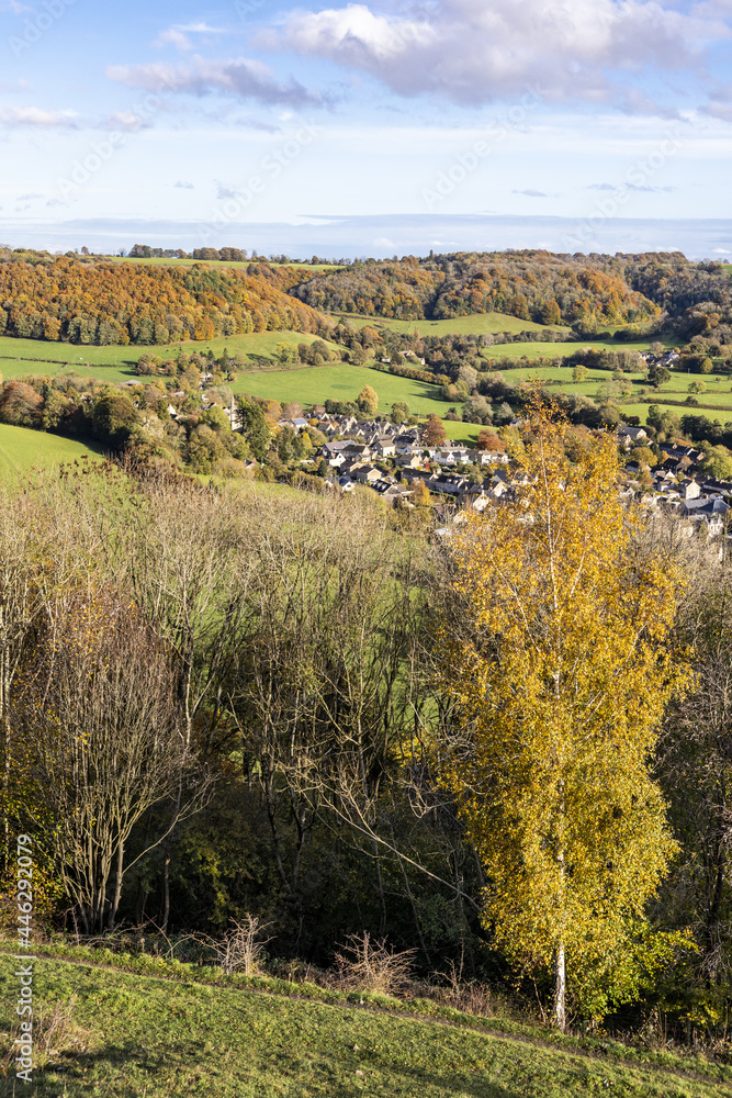 The village of Uley tucked in beneath the Cotswold escarpment viewed from Uley Bury, an Iron Age hill fort, Gloucestershire UK