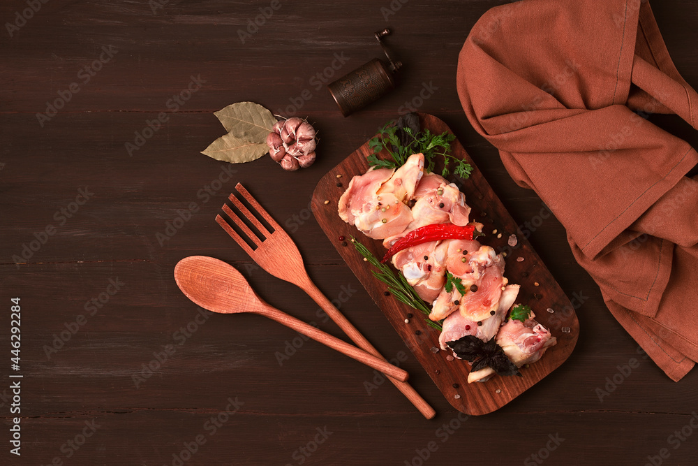 Raw chicken joints, with spices, on a  wooden table, top view, rustic style, no people,