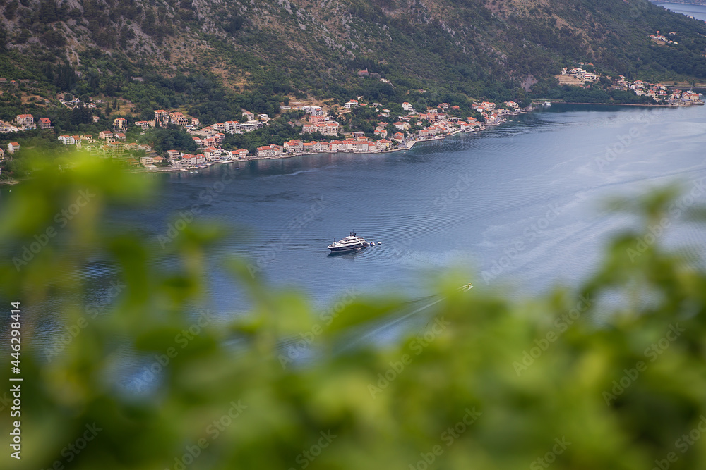 Incredibly beautiful view of the Bay of Kotor along which the yacht sails on a beautiful summer day in Montenegro. Very beautiful view of the fjord from above.