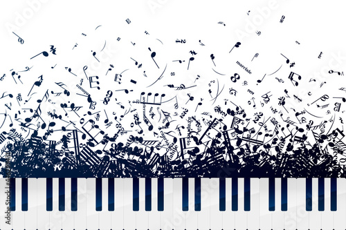 A lot of different musical notes and signs in chaotic heap with piano keyboard on white